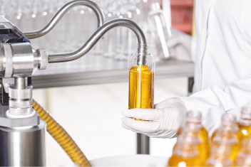 Transparent plastic bottles filled with sunflower oil on the Granja Verde factory